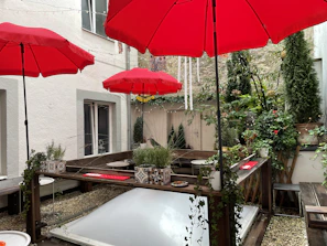 A happy customer enjoying a shaded patio with a stylish zedoviva awning overhead.