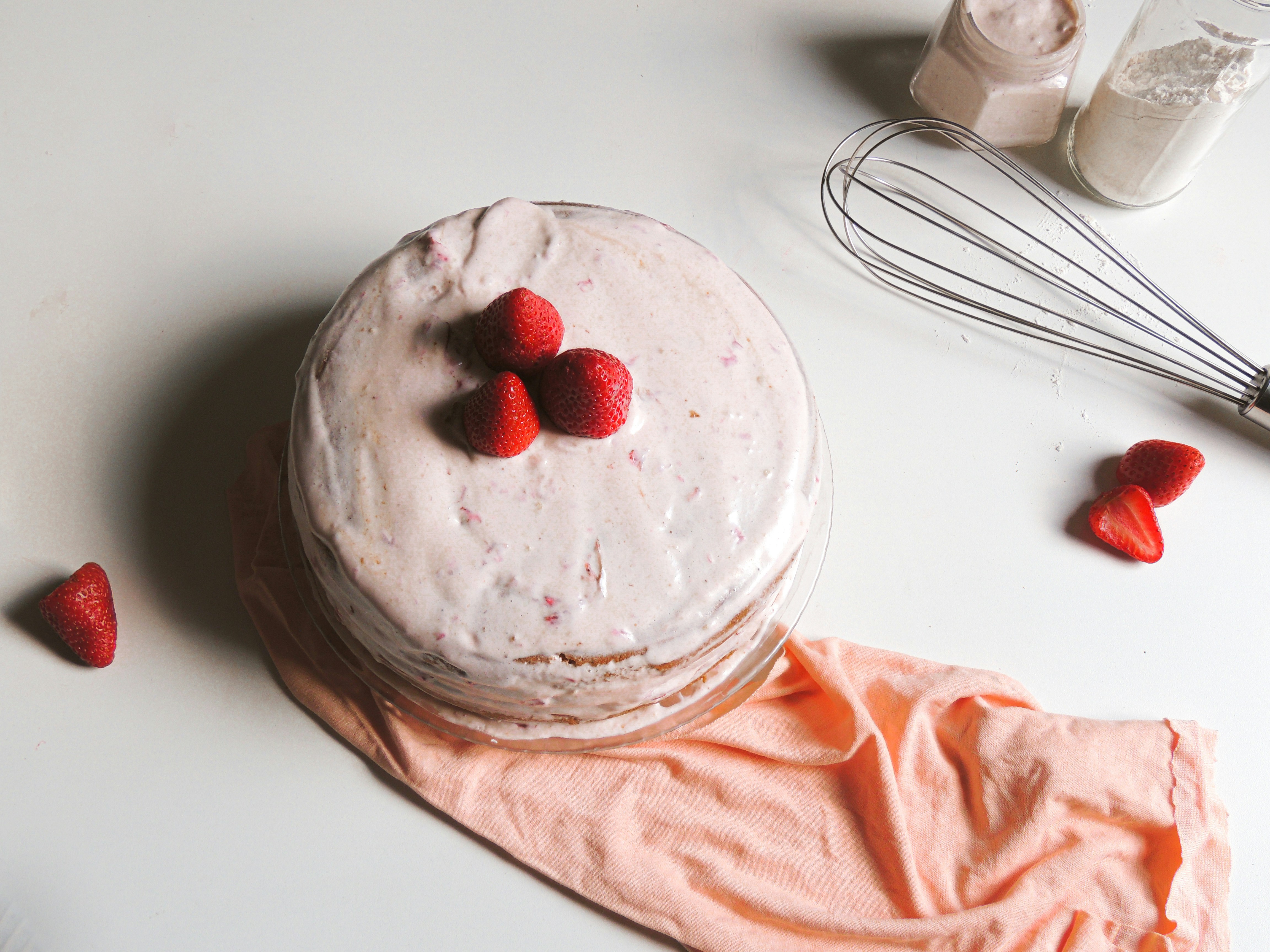 Minimalist cake on table with whisk
