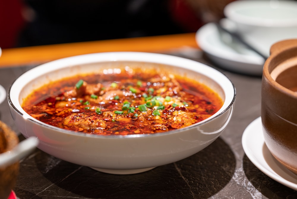 a bowl of food sitting on a table