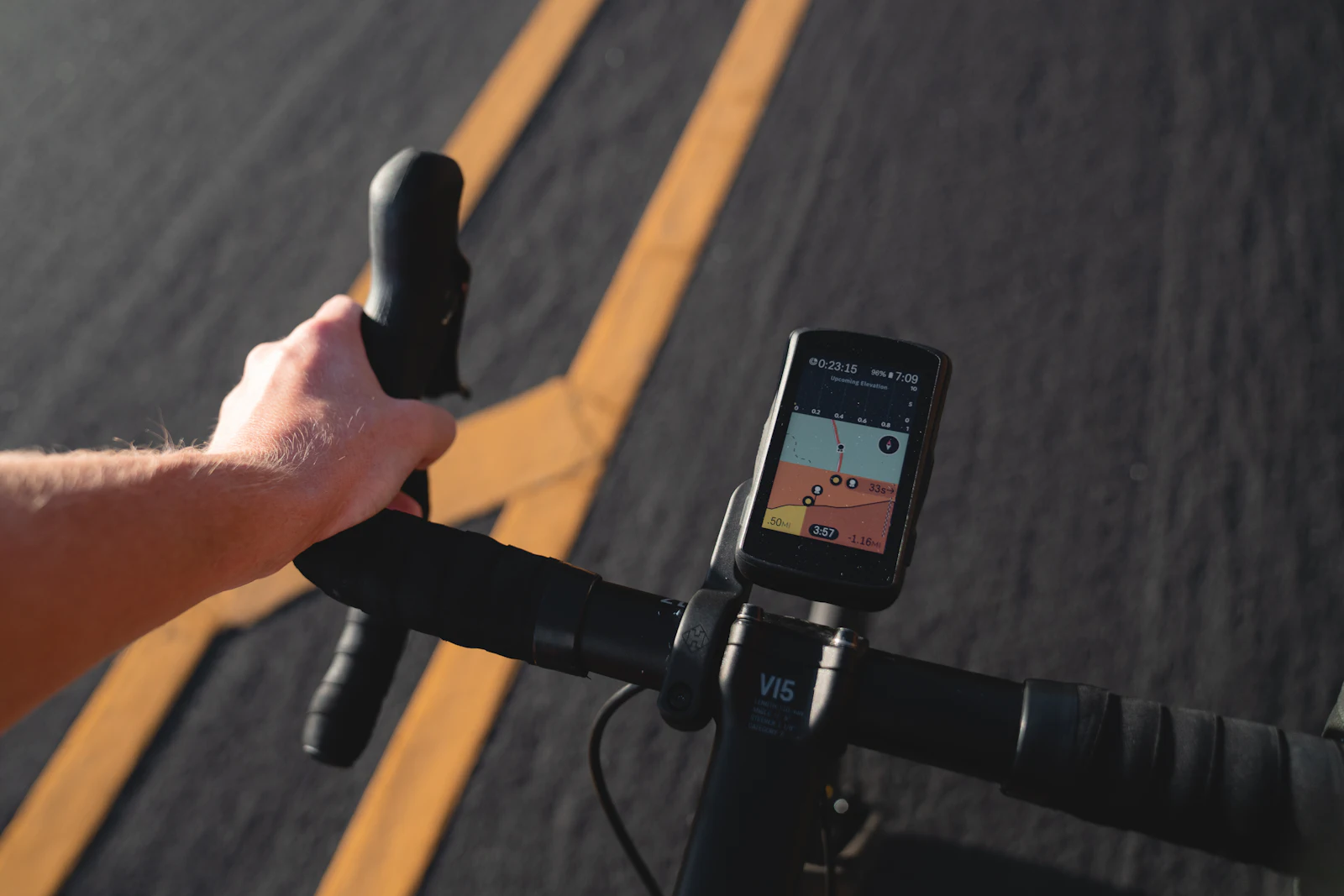 A person riding a bike with a GPS tracking app running on the handlebars
