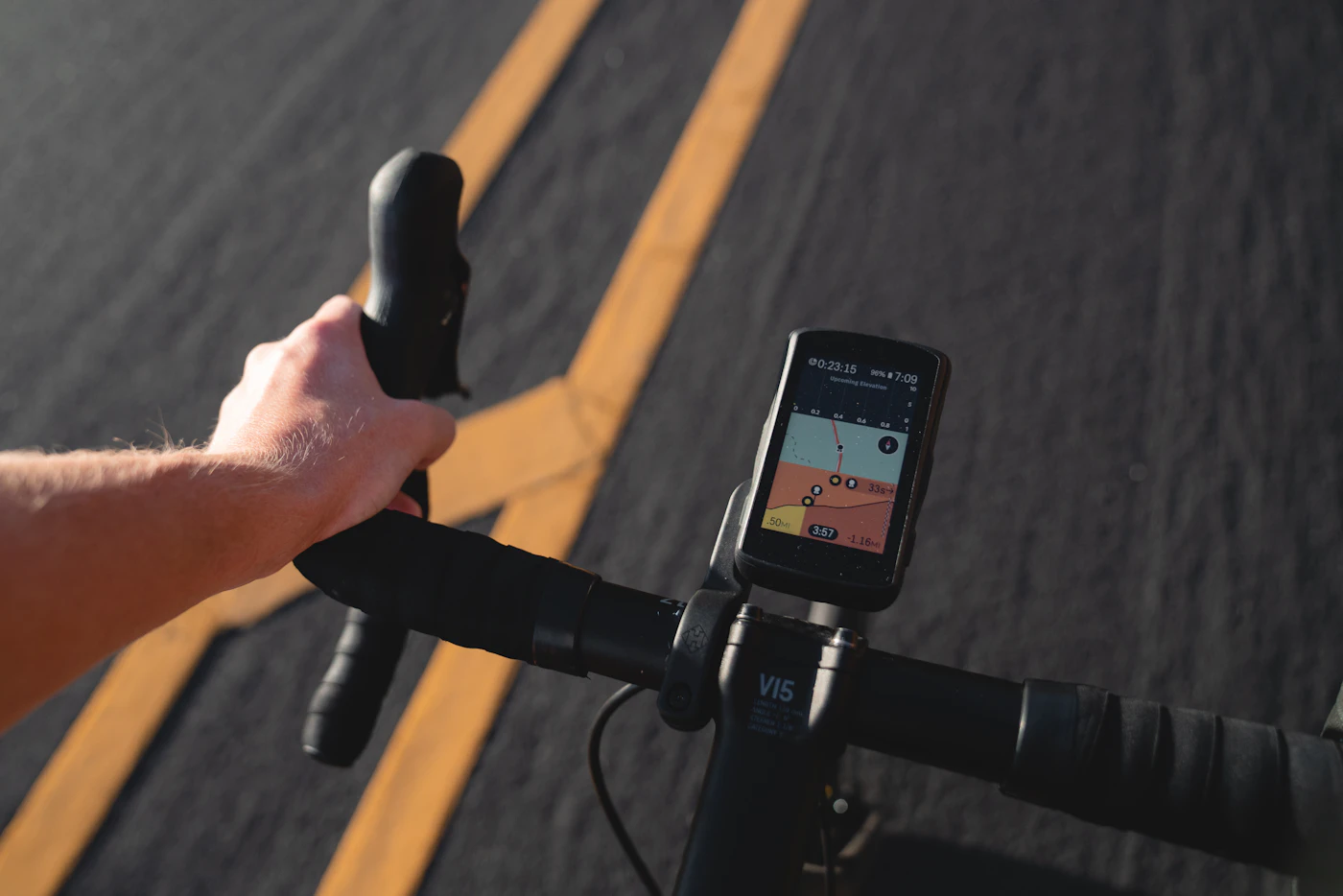 Handlebars with a bike computer mounted, showing ride data