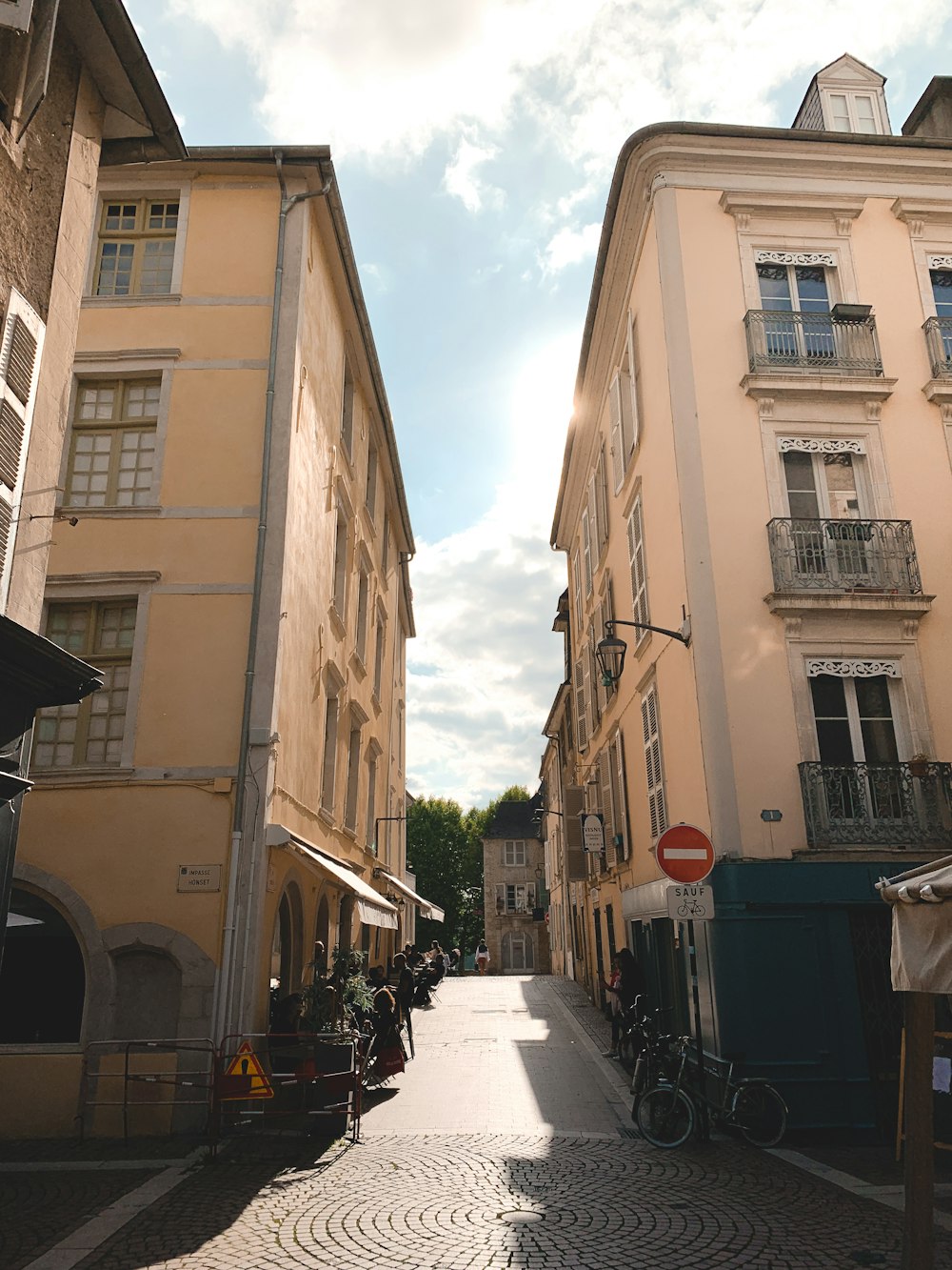 a cobblestone street lined with tall buildings