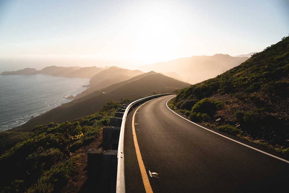 a winding road with a view of the ocean