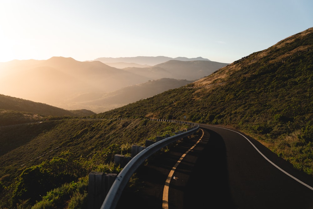 a winding road in the middle of a mountain range