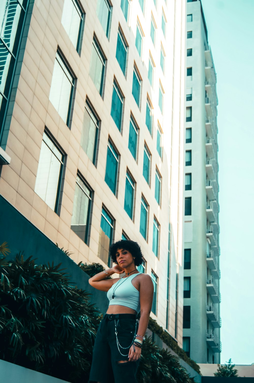 a woman standing in front of a tall building