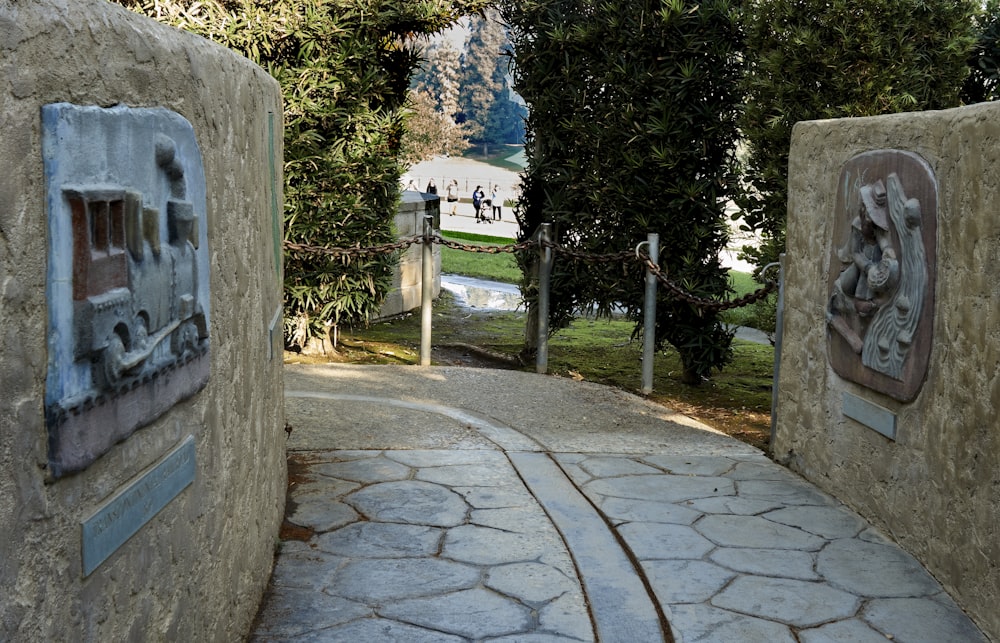 a stone walkway with a statue on the side of it