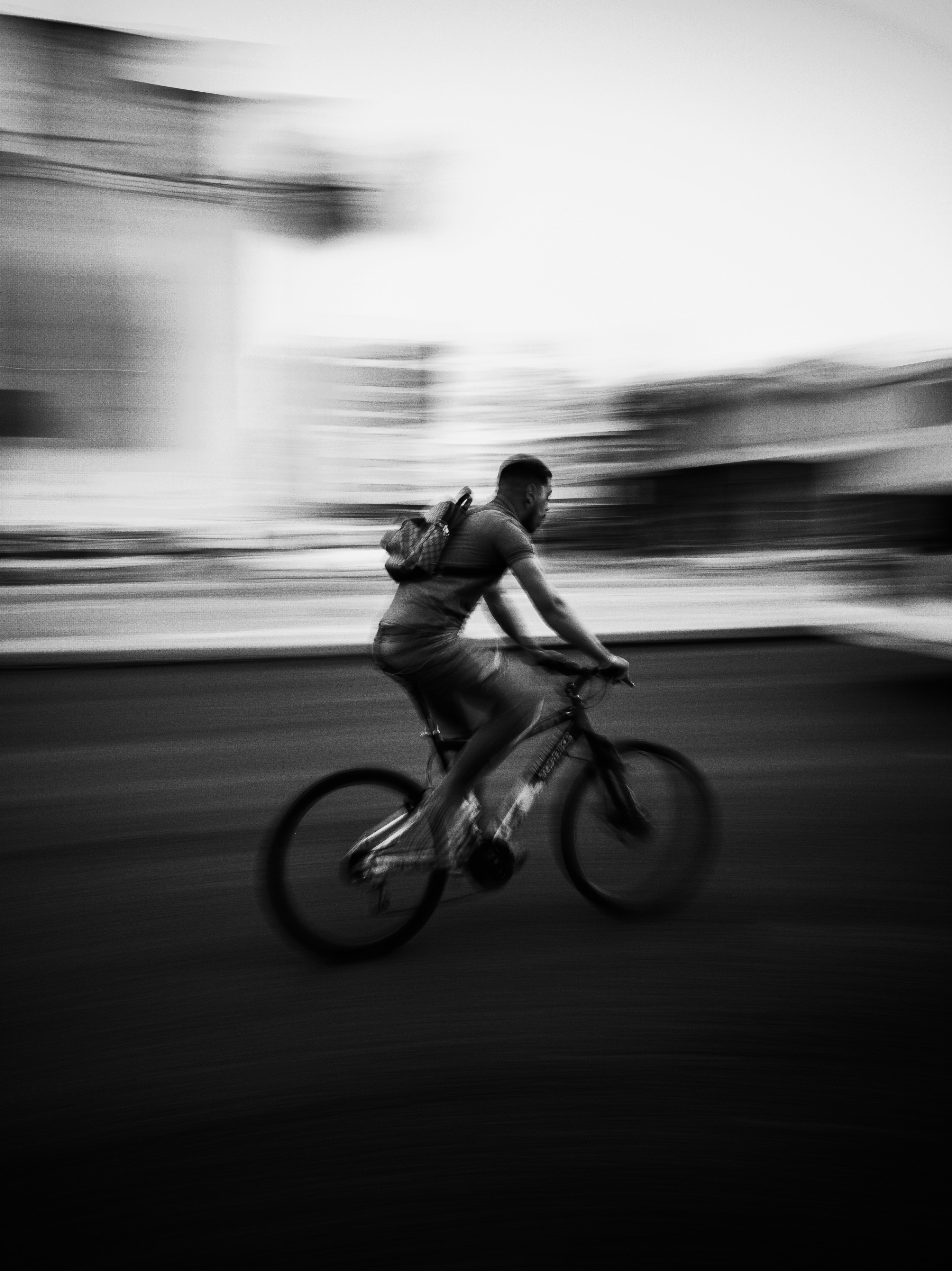 a man riding a bike down a street