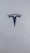 A sleek, metallic logo in the shape of a T sits prominently against a smooth, white background, conveying a sense of modern elegance and sophistication.