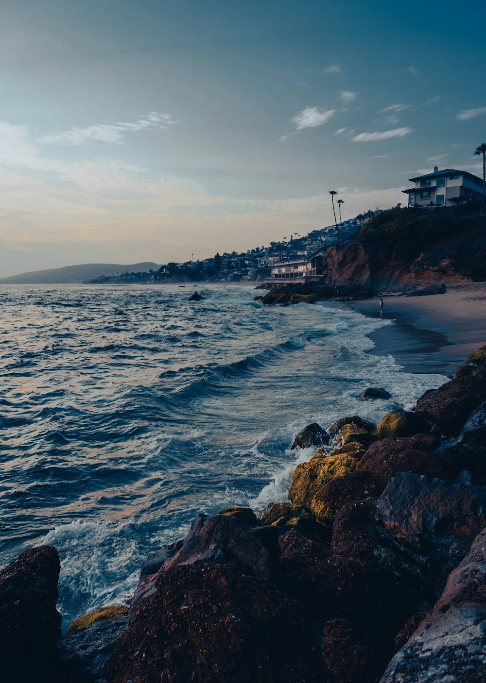 a view of the ocean from a rocky shore