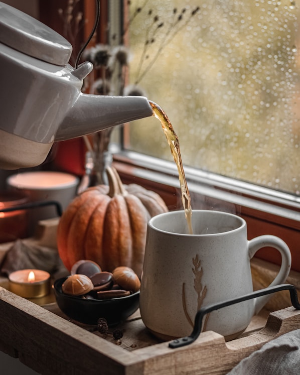 a coffee pot pouring coffee into a cup