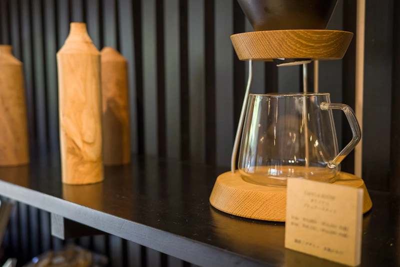 Carafe en verre de café filtre sur un plateau en bois, ambiance scandinave premium