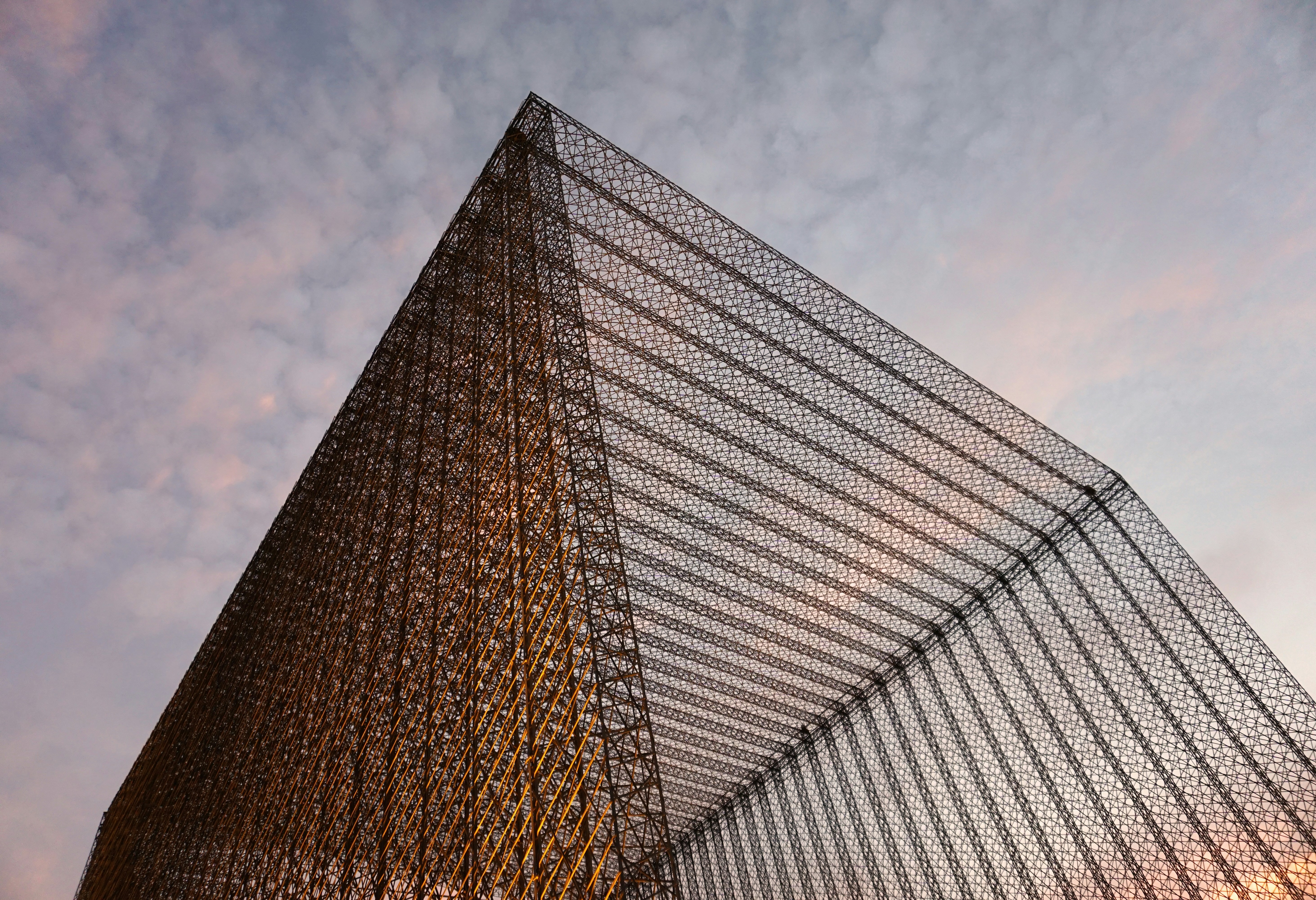 a very tall building with a very large triangular structure on top of it