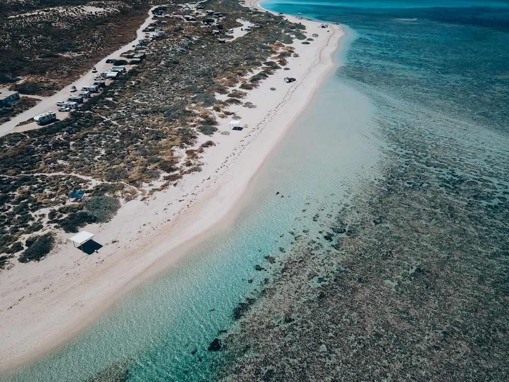 an aerial view of a sandy beach and ocean