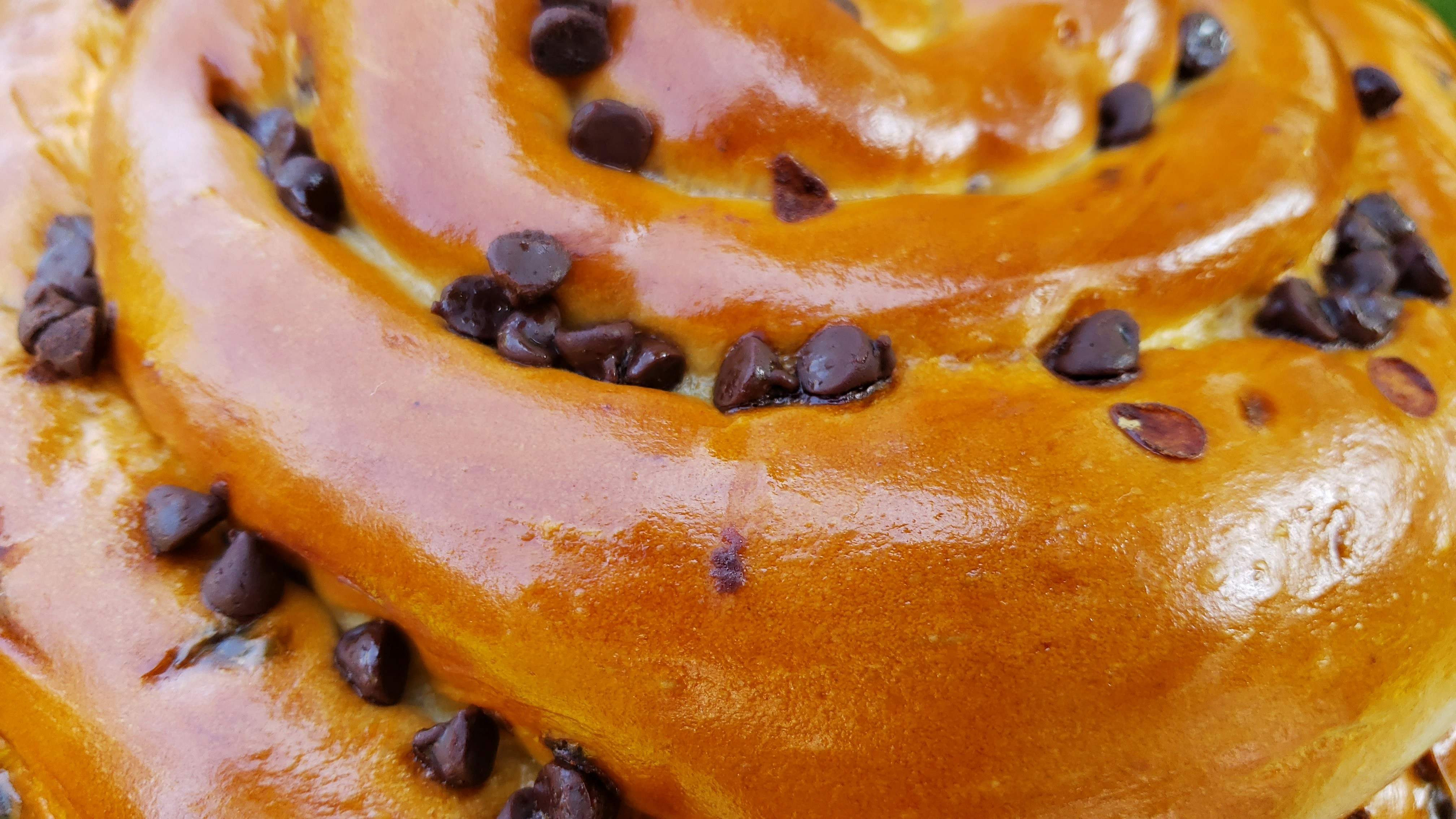 a close up of a doughnut with chocolate chips