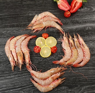 Close-up of succulent shrimp arranged neatly on a wooden platter.