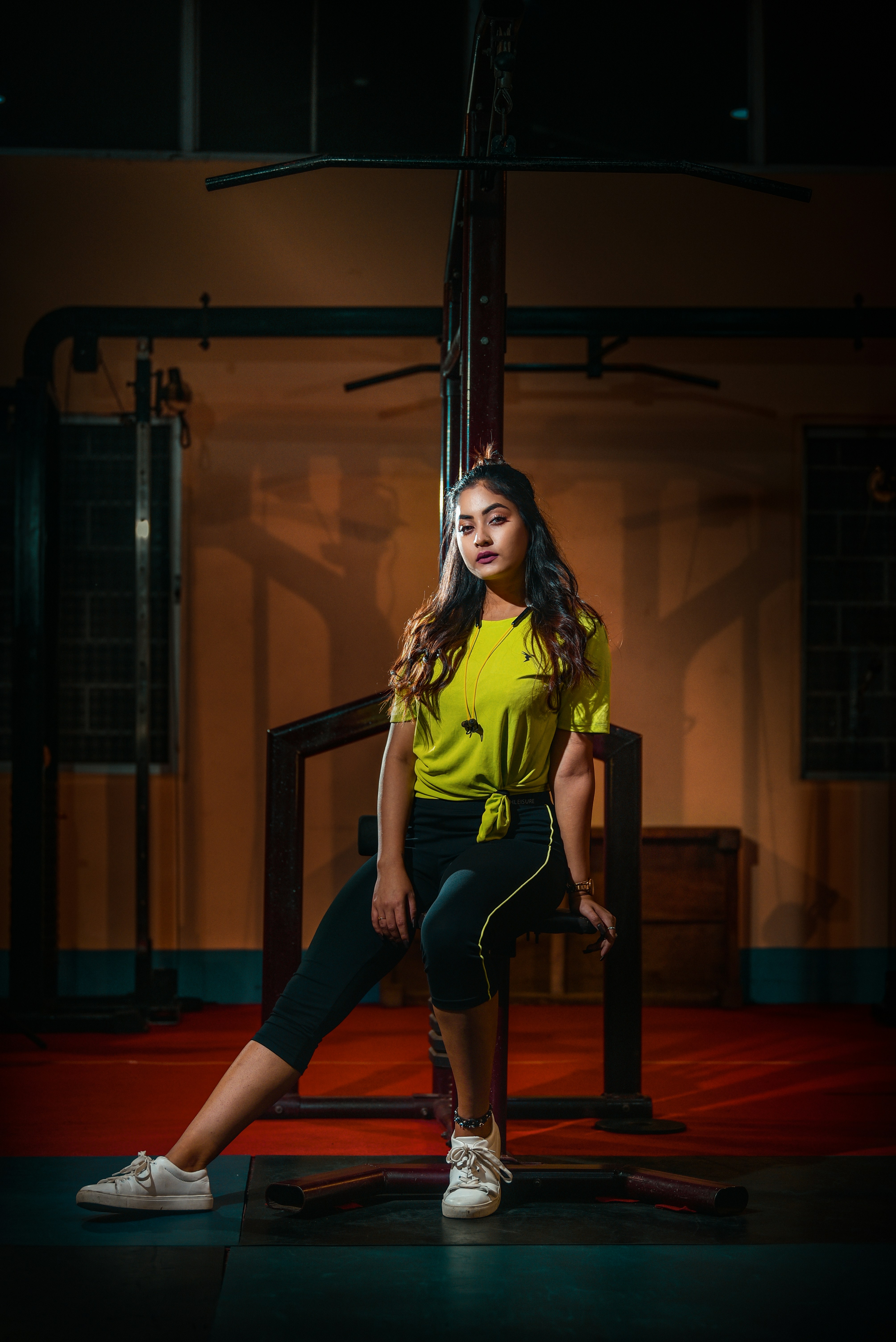a woman sitting on a chair in a dark room
