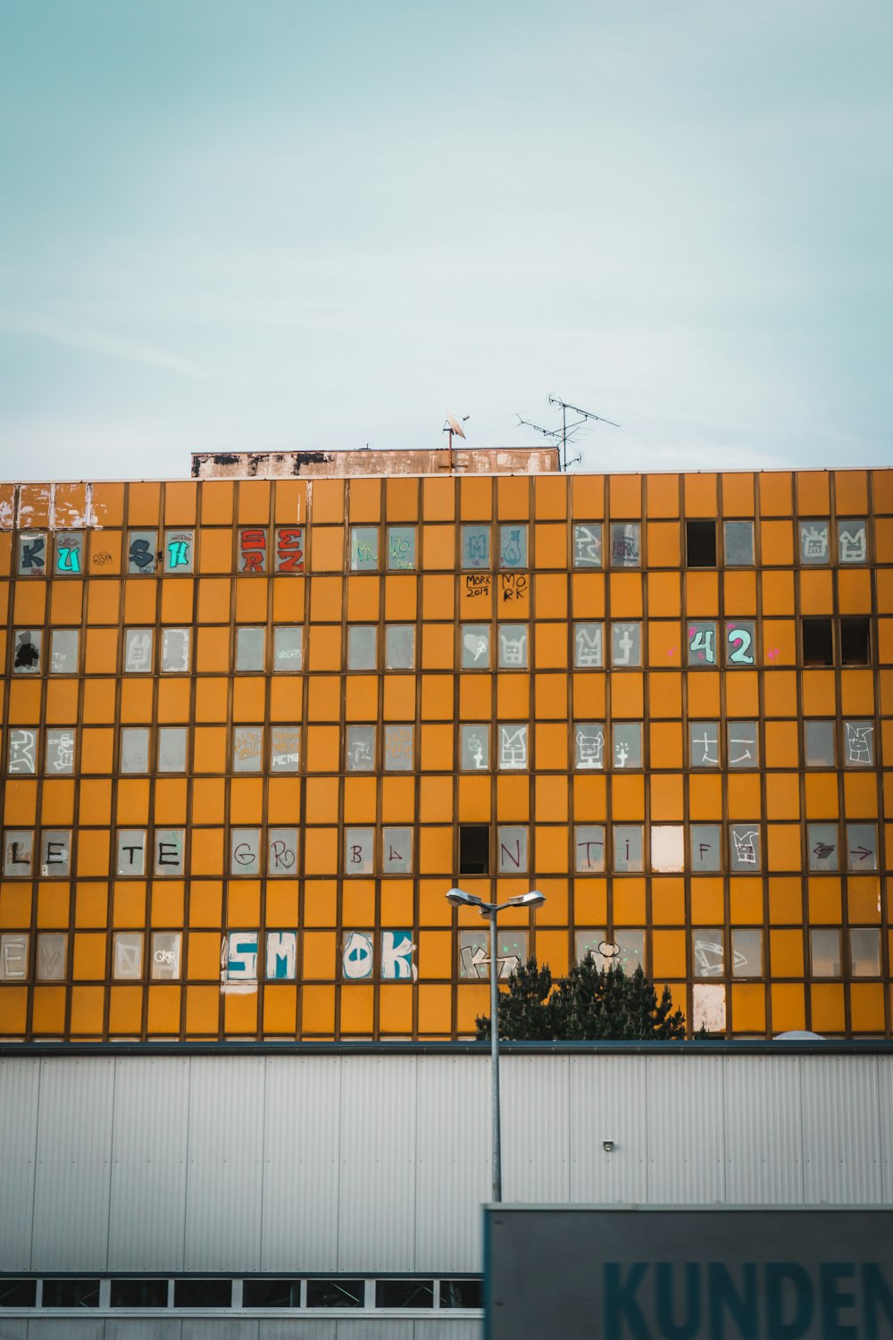 a tall orange building with lots of windows
