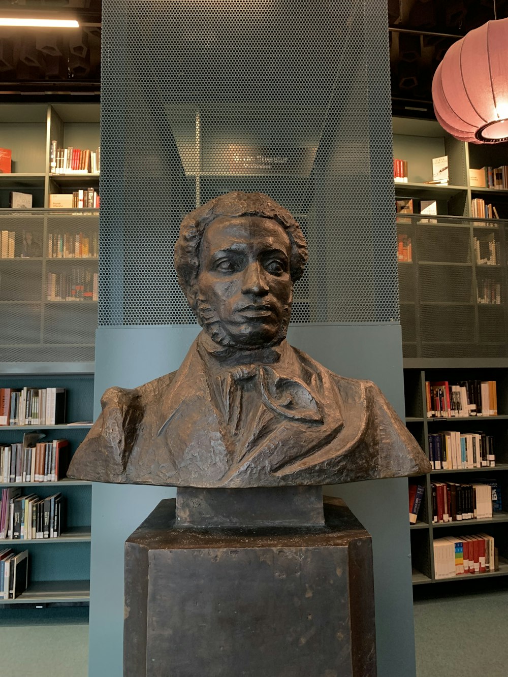 a bust of a man in a library