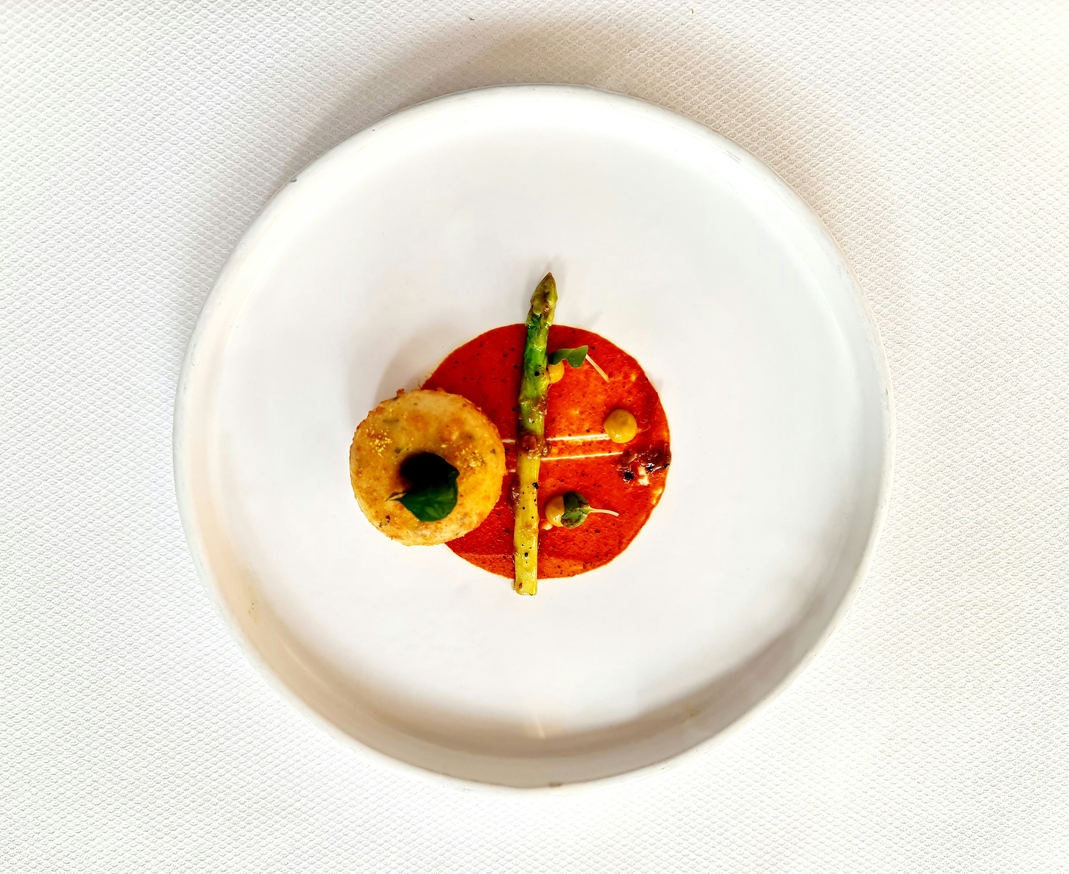 a white plate topped with a cut in half tomato, 