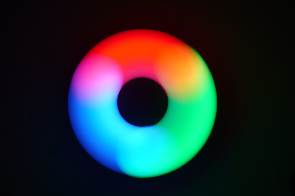 a multicolored circular object on a black background