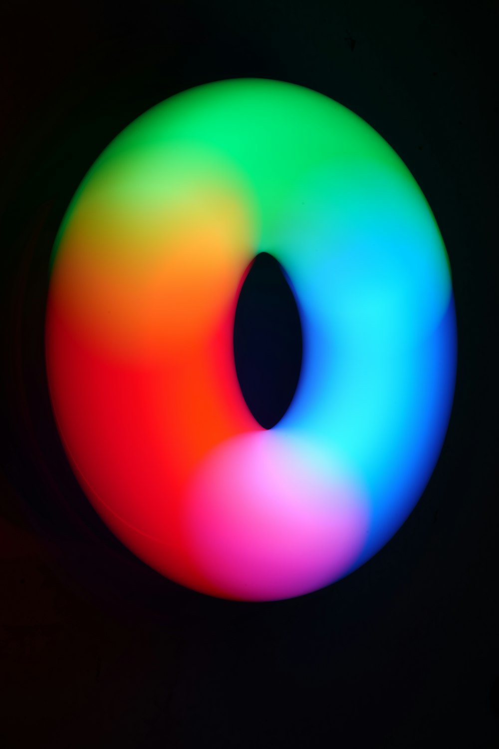 a multicolored object with a black background