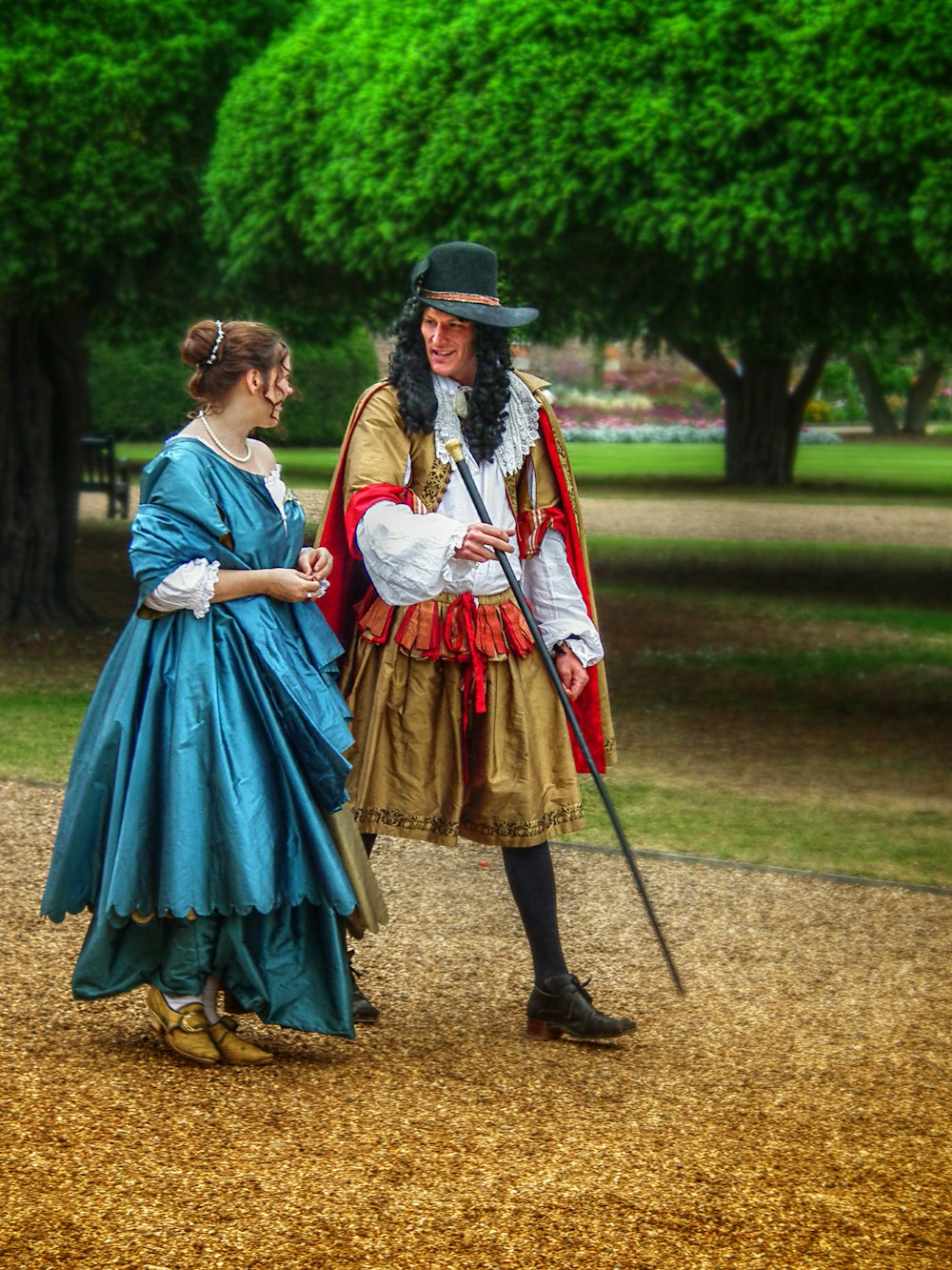 a man in a costume talking to a woman in a dress