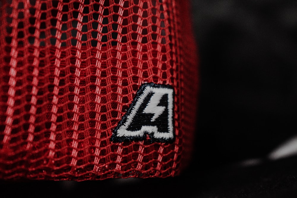 a red mesh bag with a logo on it