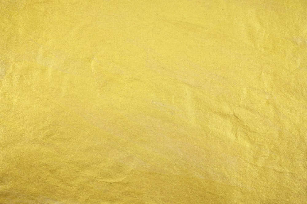 a close up of a yellow colored paper