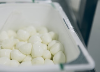 a container filled with white marshmallows sitting on top of a counter