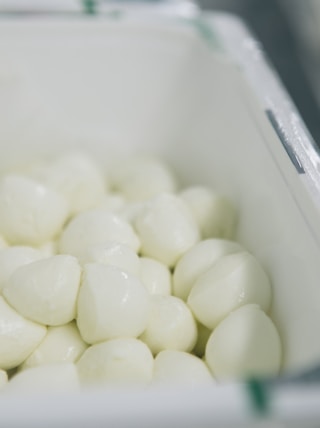 a container filled with white marshmallows sitting on top of a counter