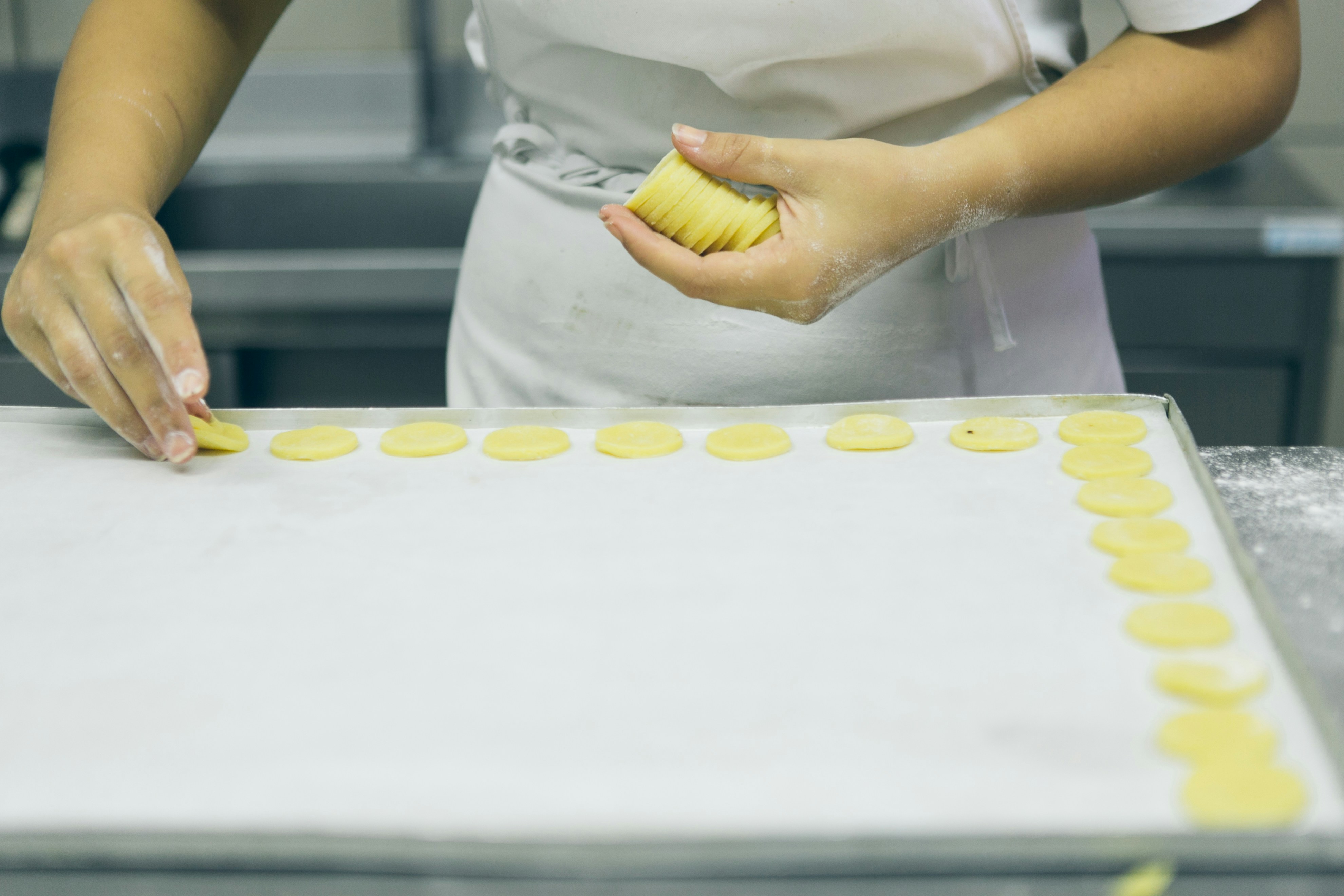 a woman is decorating a cake with icing