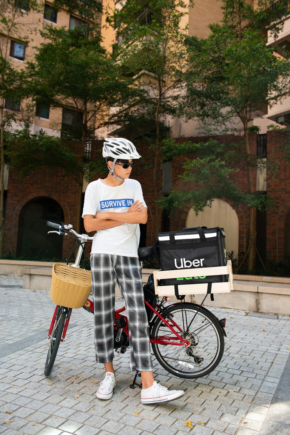 a man standing next to a bike with a basket