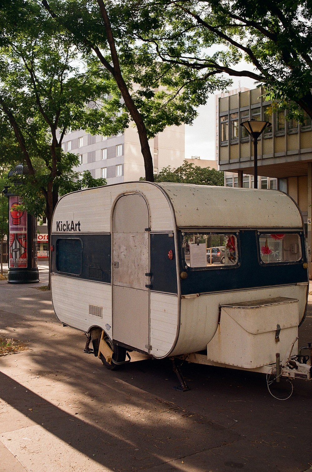 an old trailer is parked on the side of the road