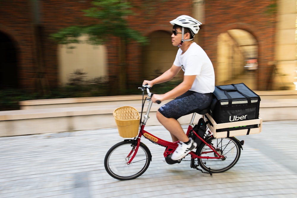 a man riding a bike with a basket on the back