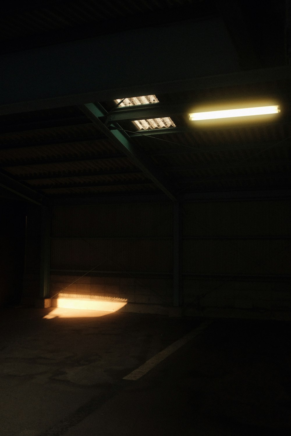 an empty parking garage with the light coming through the windows