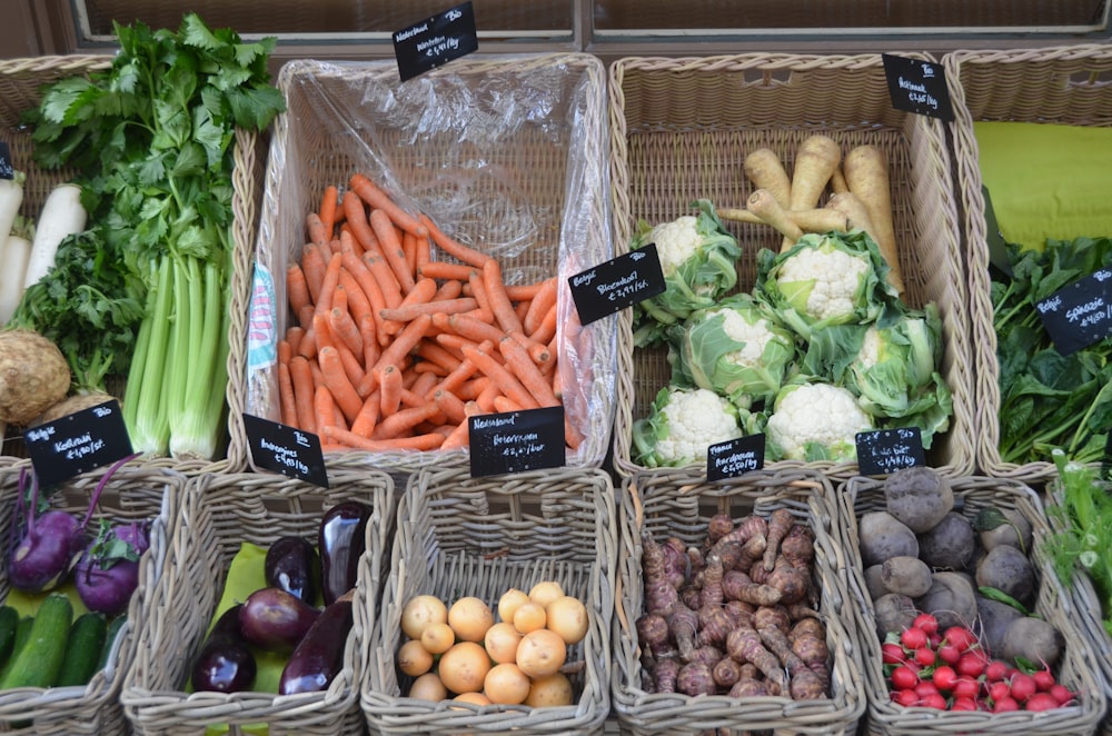 a variety of vegetables are displayed in baskets