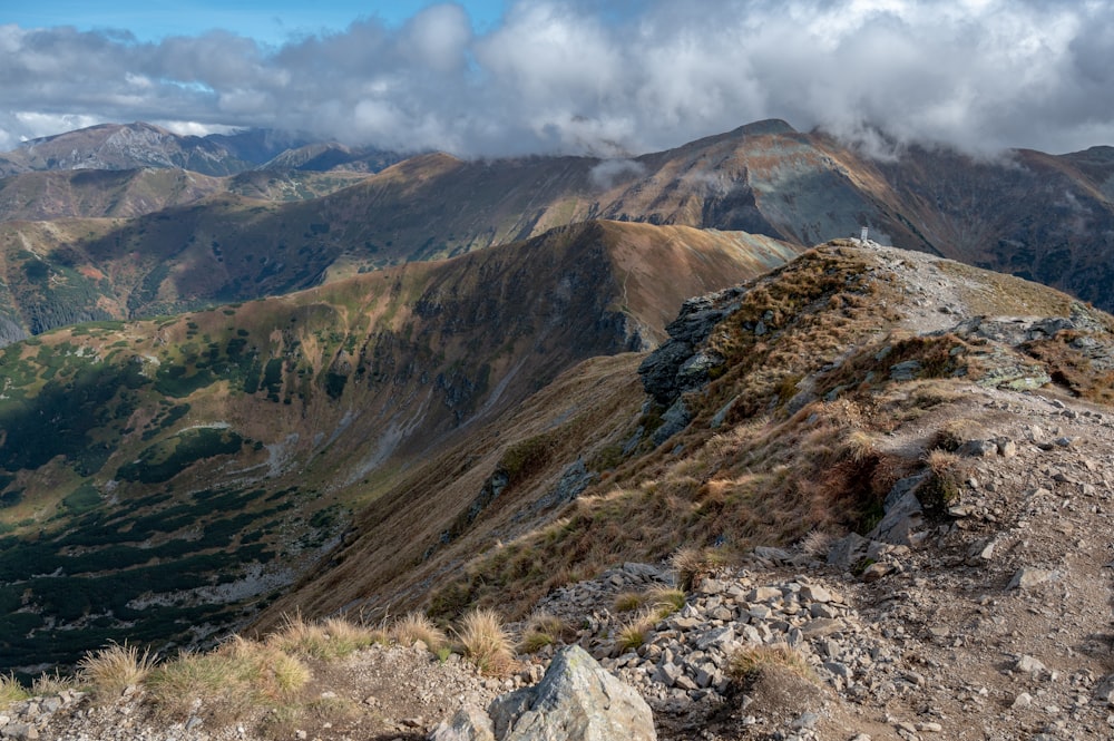 a view of a mountain range from the top of a hill