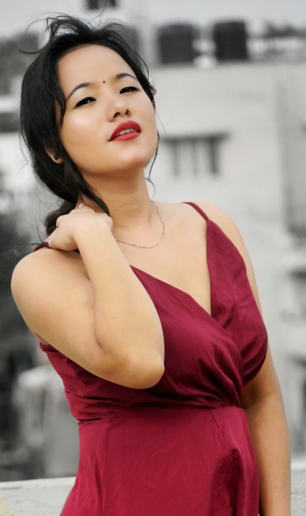 a woman in a red dress posing for a picture