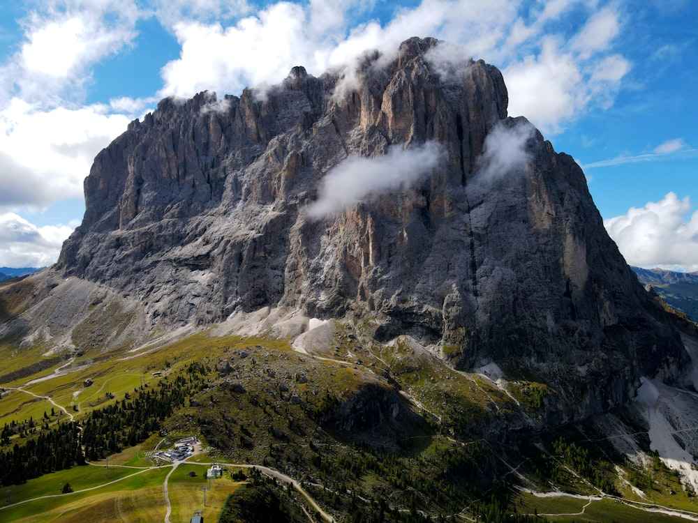 a very tall mountain with some clouds in the sky