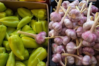 a box of garlic next to a box of peppers