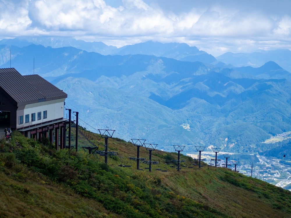 a house sitting on top of a lush green hillside