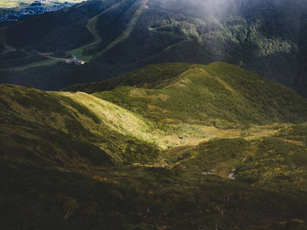 a scenic view of a mountain range with a valley in the foreground