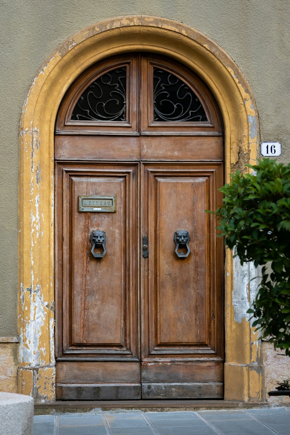 a large wooden door with a number on it