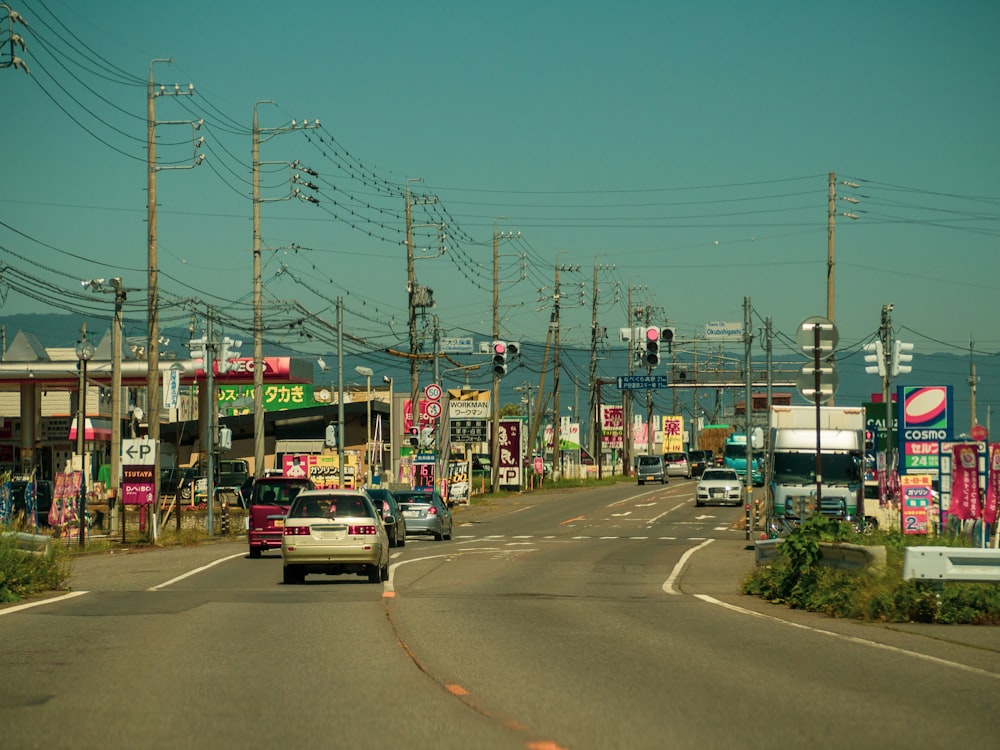 a car driving down a street next to power lines