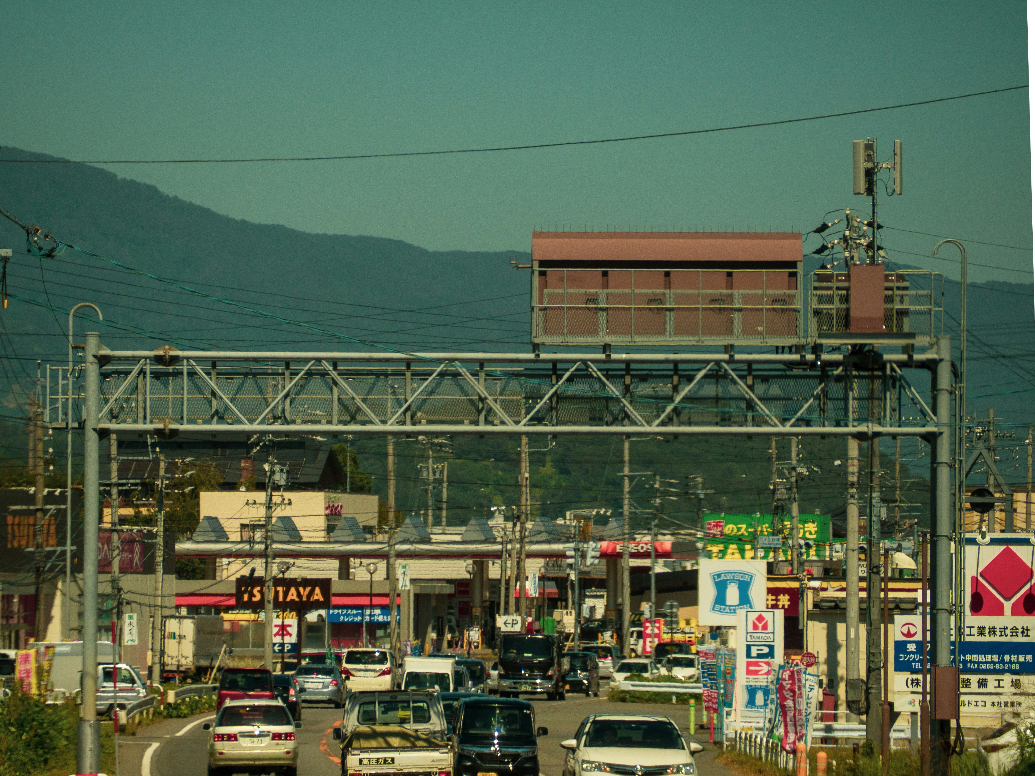 a city street filled with lots of traffic under power lines