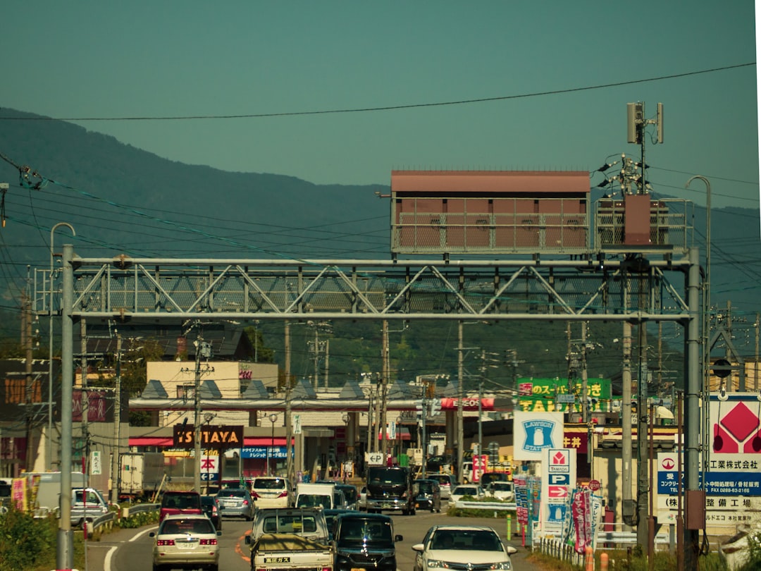 a city street filled with lots of traffic under power lines,