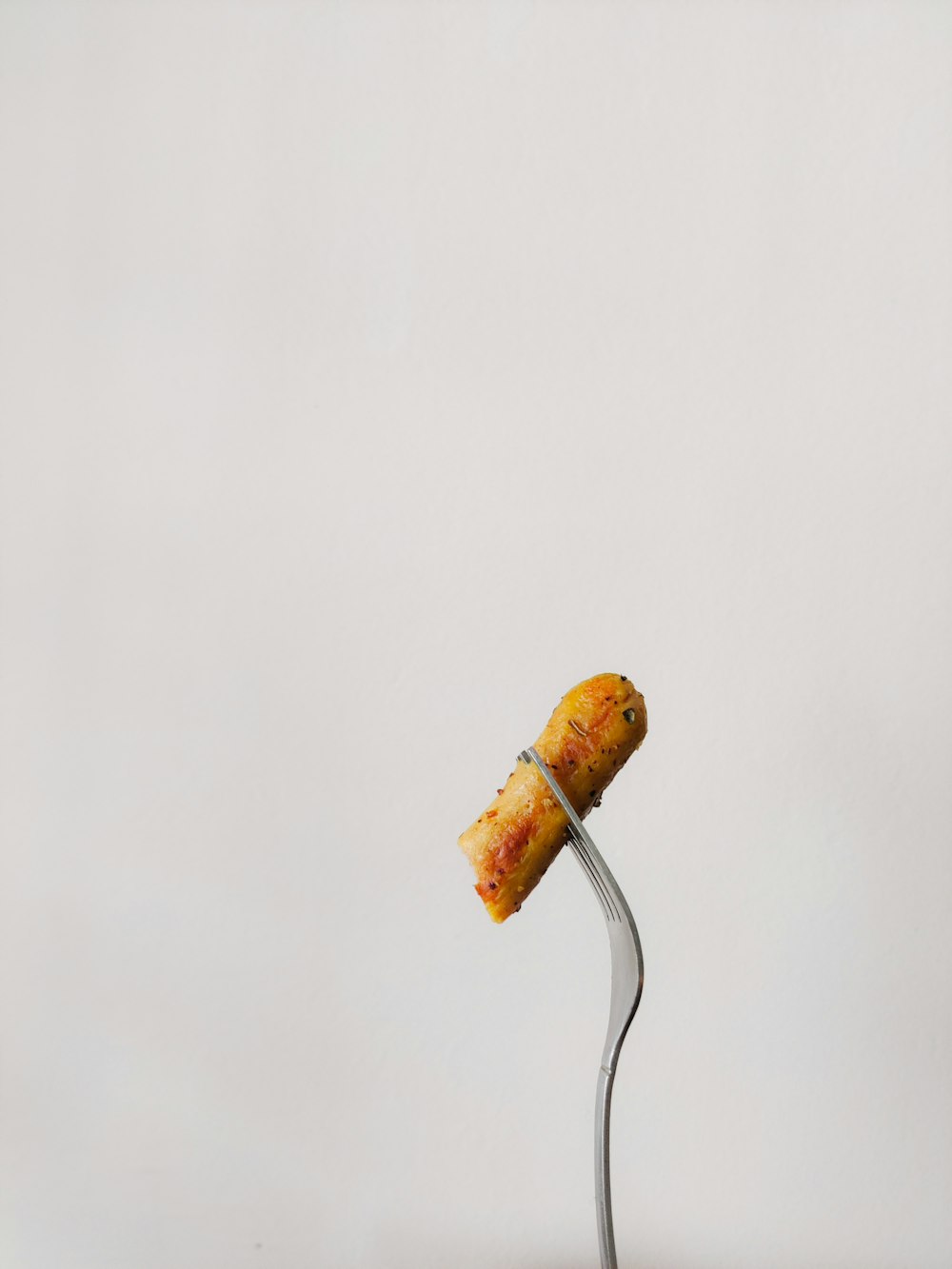 a wine cork on a metal stand with a white background