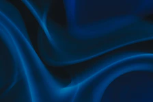 a blue and black background with wavy lines