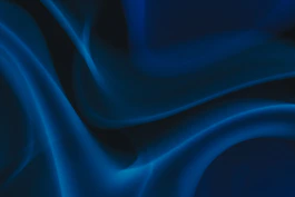 a blue and black background with wavy lines
