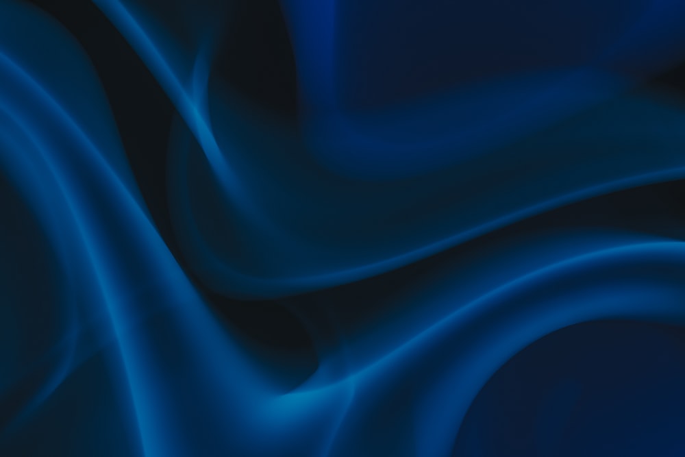 um fundo azul e preto com linhas onduladas